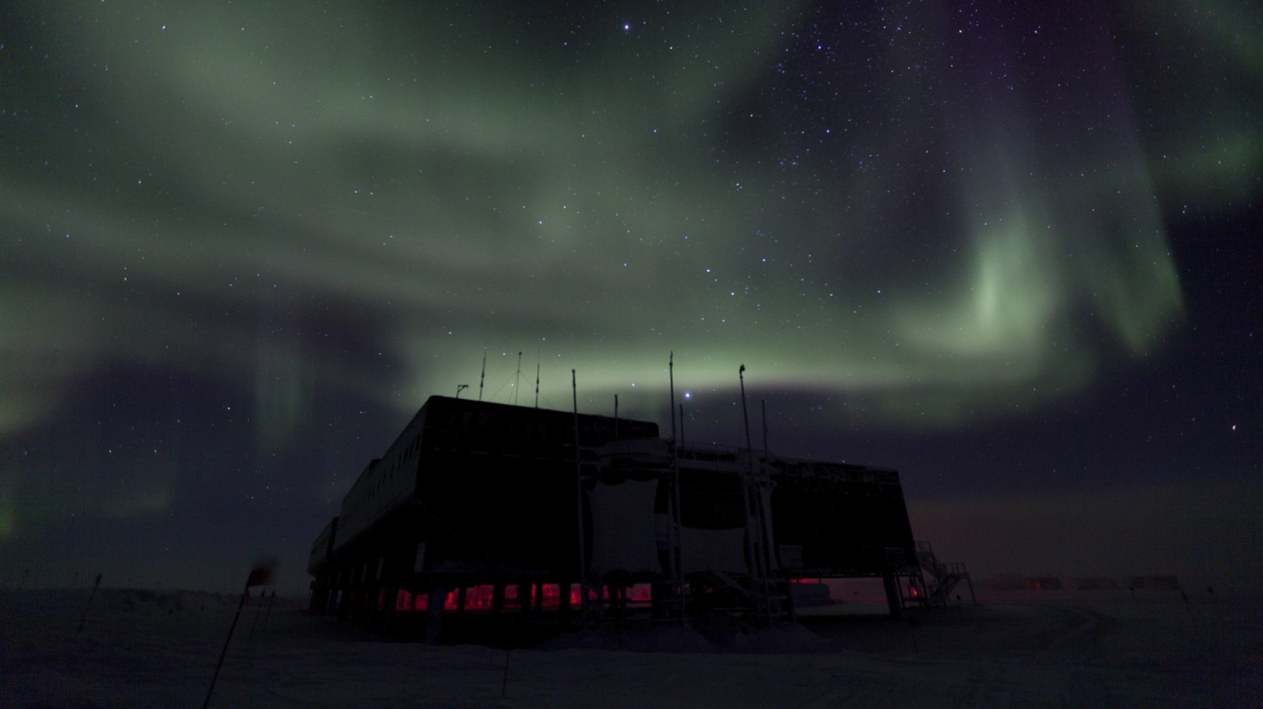 Polar lights over the IceCube laboratory. (Credit: Freija Descamps/NSF, 2011) Polar lights over the IceCube laboratory during the polar night, with a starry sky in the background. (Credit: Freija Descamps/NSF, 2011)